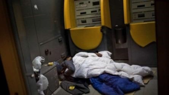 “Desamparado. Dos hombres duermen
en un cajero en Barcelona, una ciudad atravesada por la crisis”